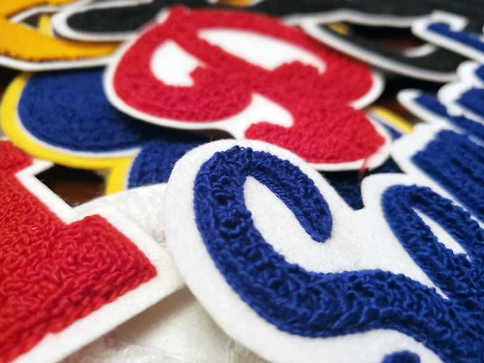 Custom chenille letter patches on a letterman jacket